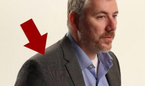 An example of the moire effect on a businessman's blazer. A red arrow is pointing to the exact spot where it is visible to the camera.