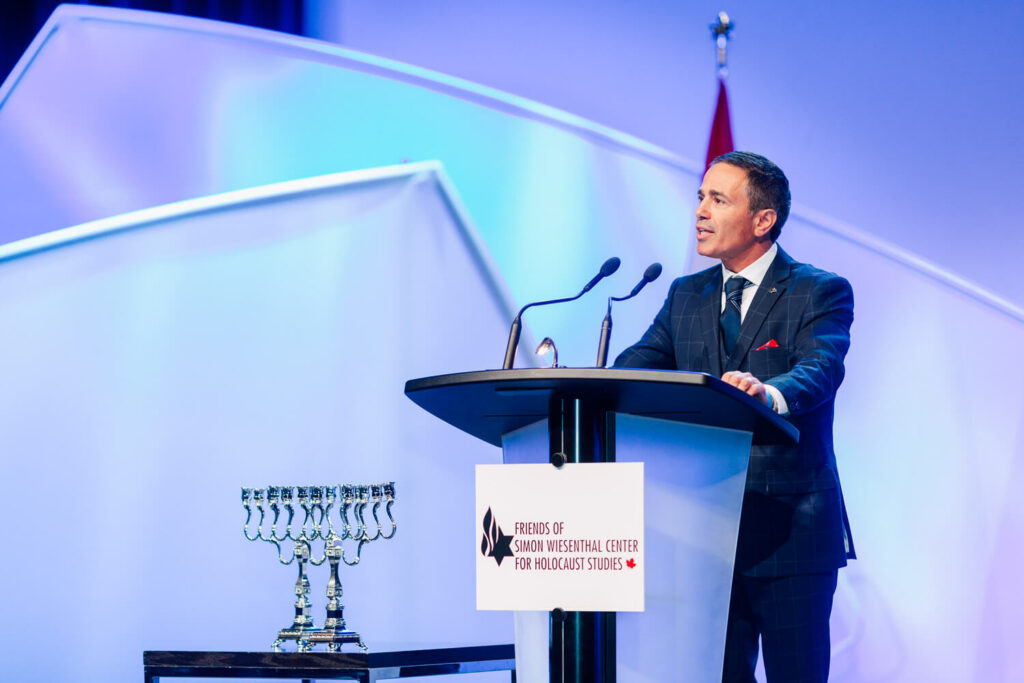 A businessman speaking at a podium in a business conference. 