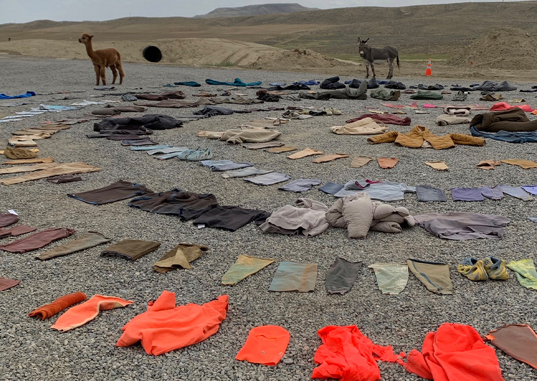 Clothing from a yeezy gap sample collection in a circle on the ground outside of Wyoming.