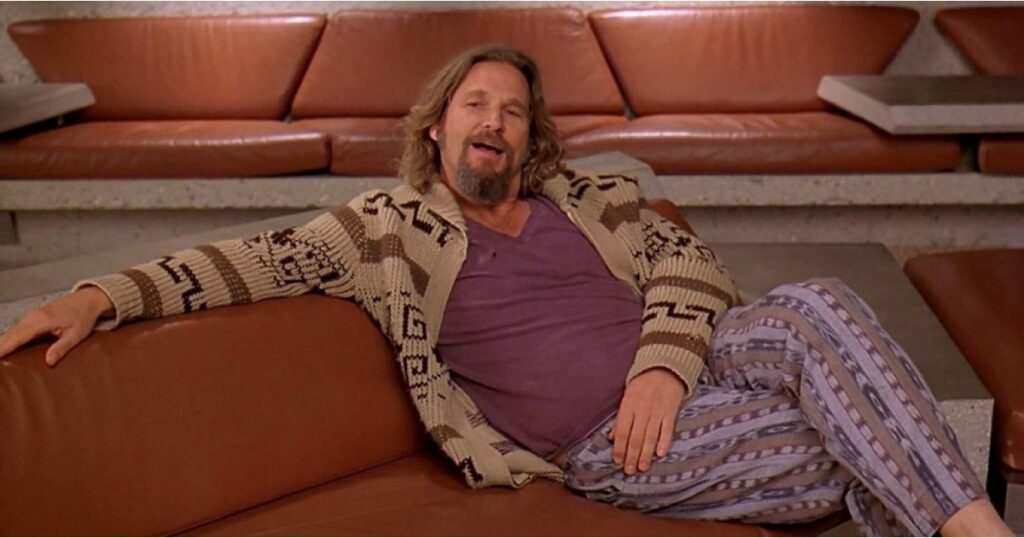 The dude from The Big Lebowski movie in the scene where he is seated on a couch in his pajamas.