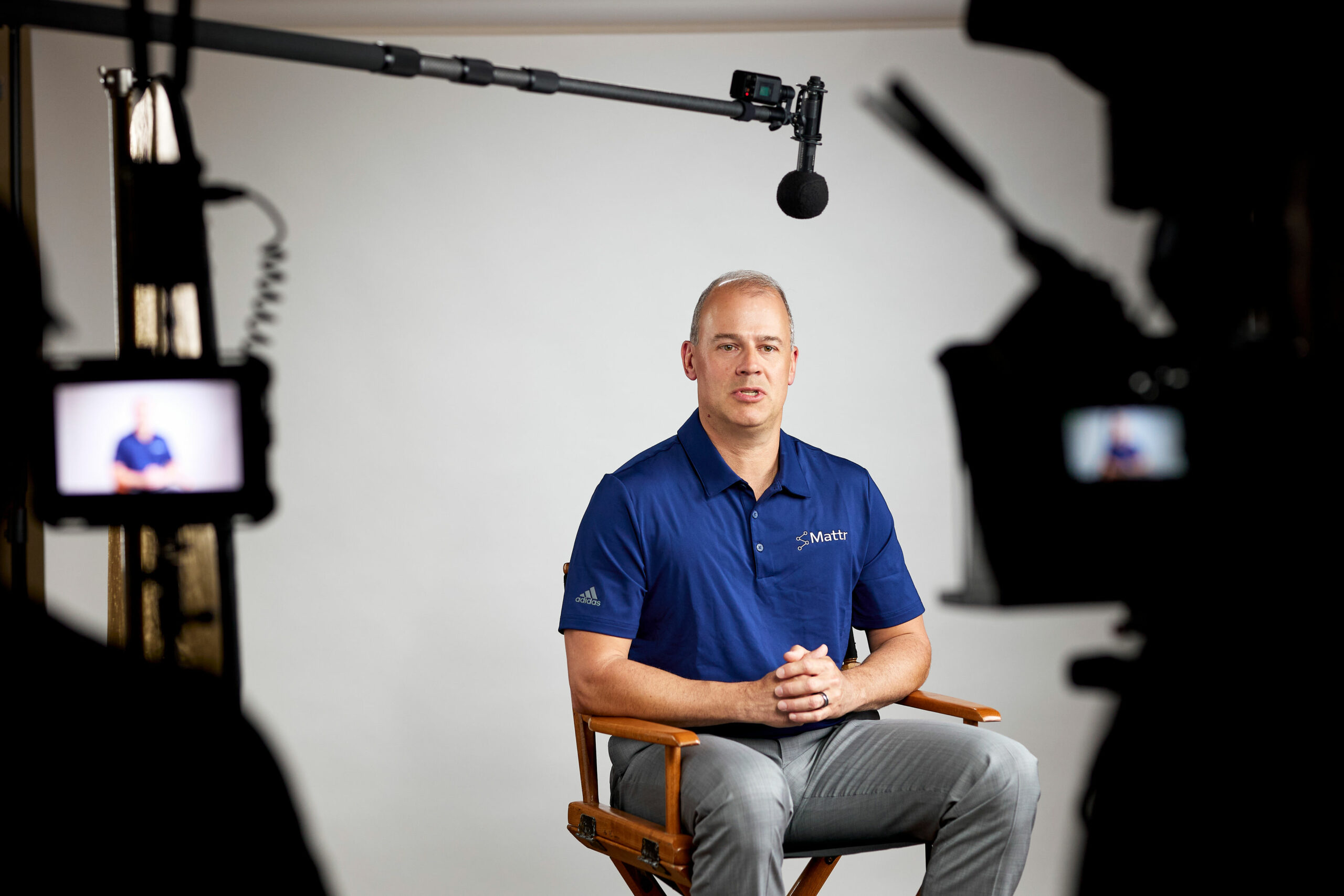 Behind-the-scenes image of a CEO being interviewed during a video production shoot.