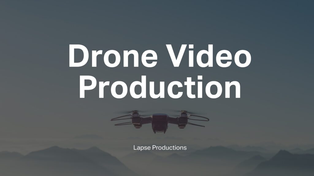 A DJI drone in the sky with the mountains in the background with the words 'Drone Video Production' and 'Lapse Productions' superimposed on it.